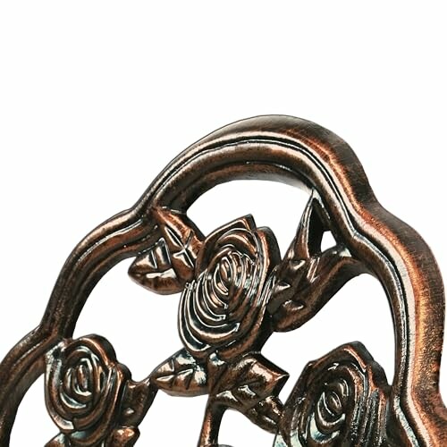 Close-up of a decorative metal design with rose patterns.
