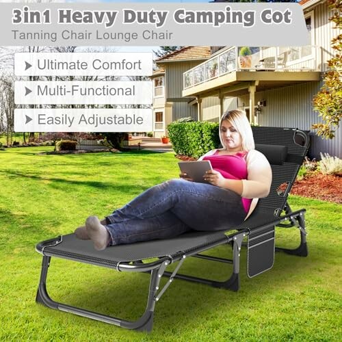 Person relaxing on a heavy duty camping cot in a backyard.