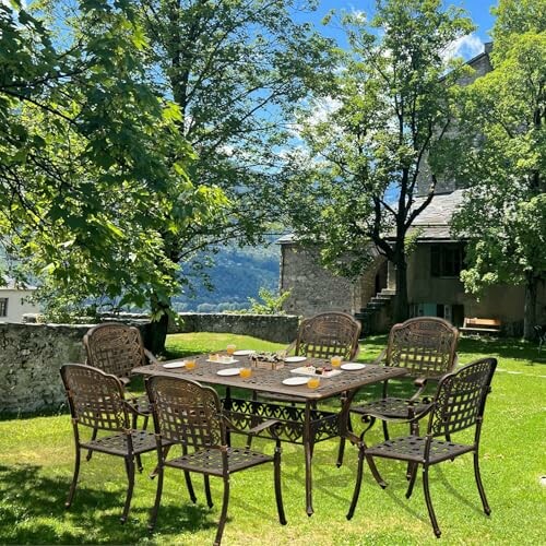 Outdoor dining set with eight chairs on grassy area under trees.