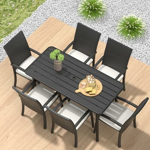 Outdoor patio dining set with six chairs and a table.