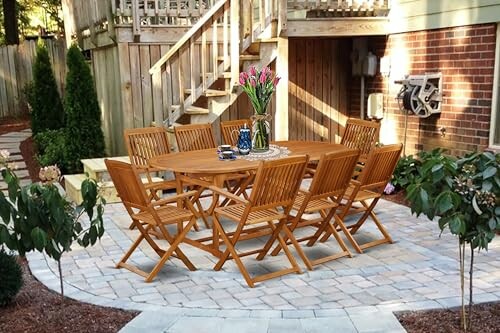 Wooden dining set on a patio with brick wall and stairs in the background.