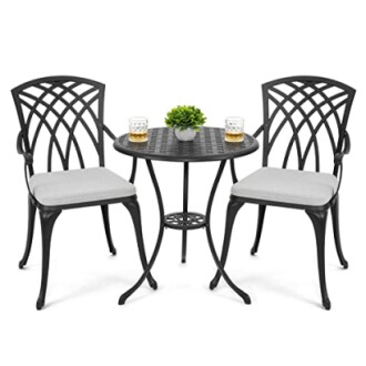 Black metal patio bistro set with two chairs and a round table.