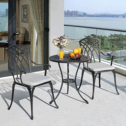 Outdoor patio with chairs, table, and fruit bowl.