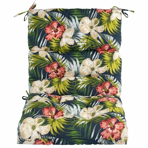 Cushion with tropical floral pattern featuring red and white flowers and green leaves.