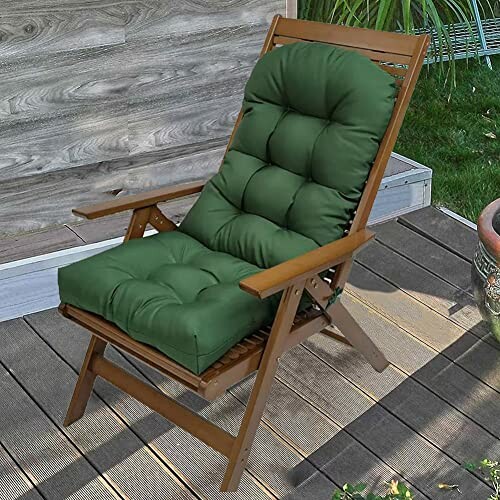 Wooden patio chair with green cushion on deck.